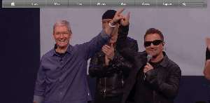 CEO,  Tim  Cook  and  U2's  Bono  demonstrate  finger  kiss.